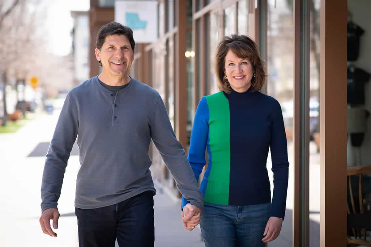 Tim and Karen holding hands, walking down the sidewalk